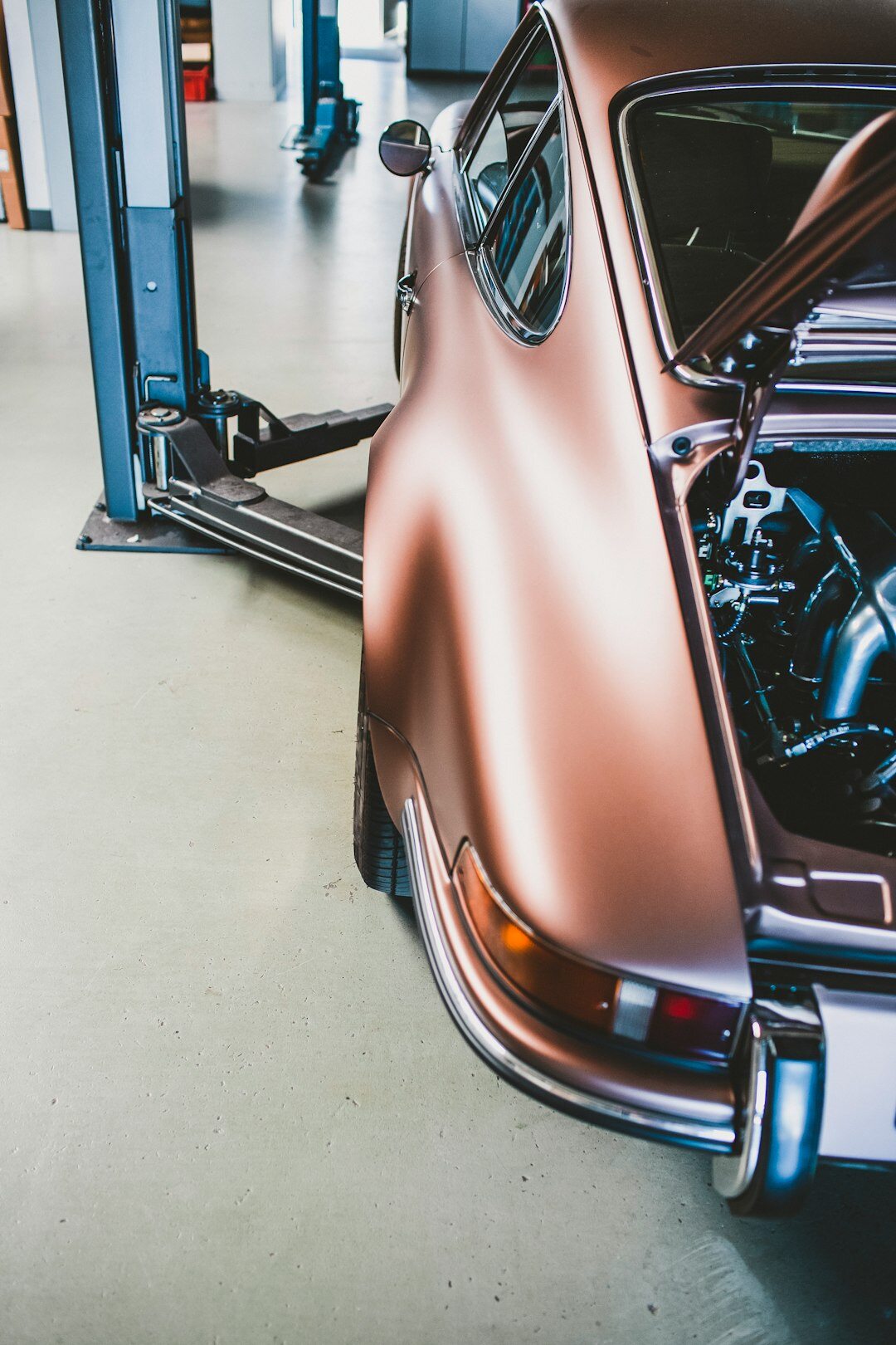 Restoration workshop with a classic automobile under detailed inspection