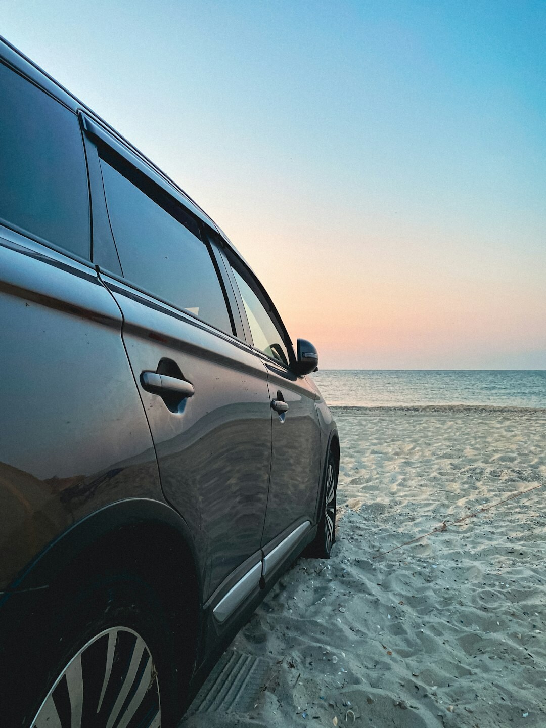 Luxury convertible automobile parked along the coastline of Jose Ignacio