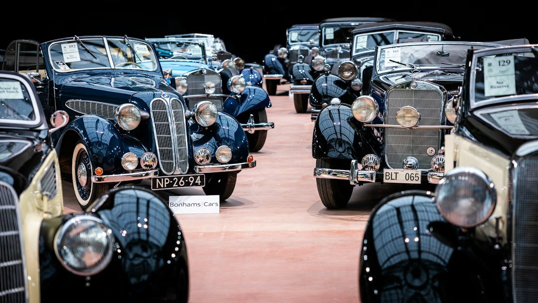 Hidden private collection of classic automobiles covered in dust and shadow