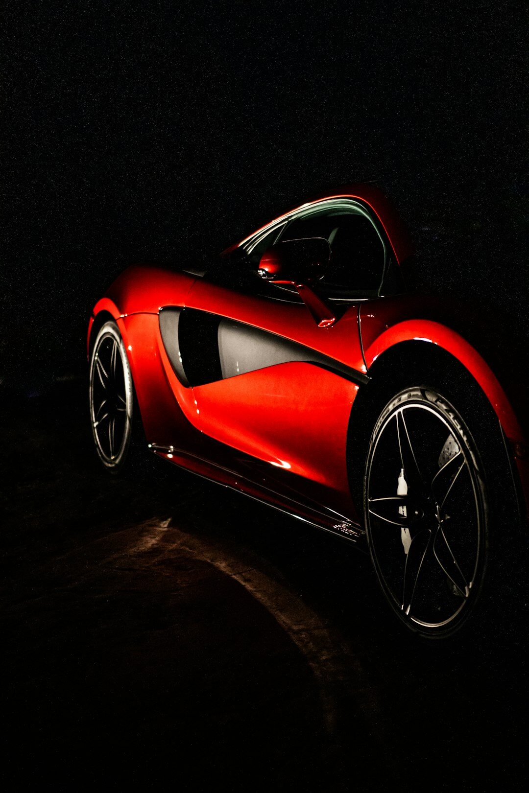 Modern hypercar with sculpted bodywork photographed at night