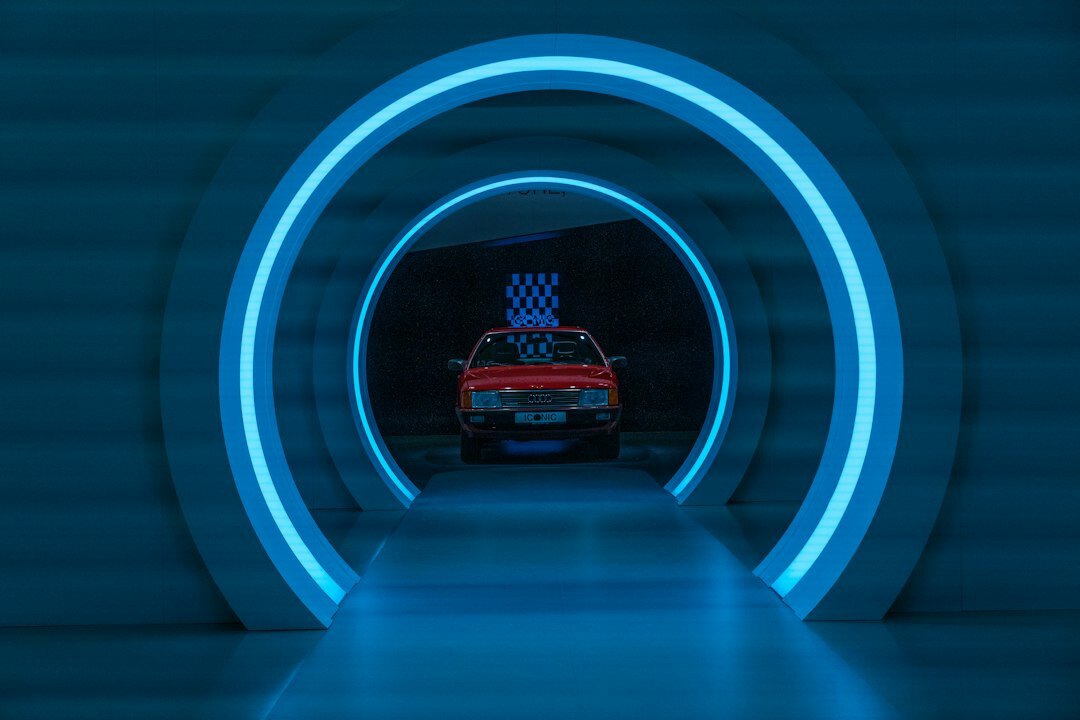 Futuristic digital gallery displaying a rotating automobile hologram